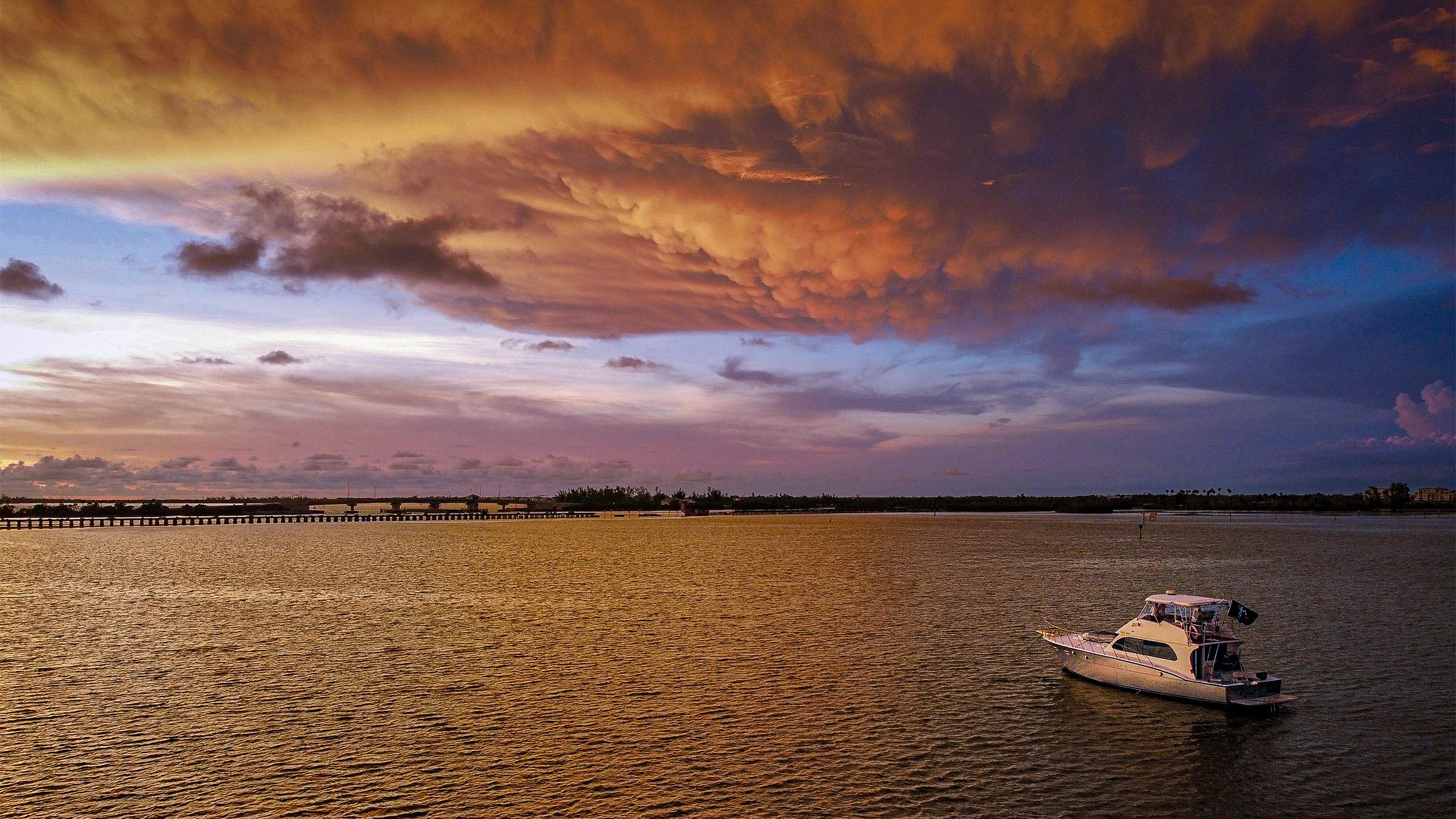 Knot Today, a sportfisher anchored in Charlotte Harbor under a dramatic mammatus sunset at dusk